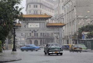 Traffic passes by the entrance to Havana's Chinatown