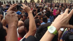 In the center, with white cap and telephone, the young man who was mistaken for Barack Obama