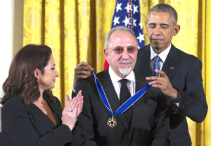 Gloria Estefan, left, watches as President Barack Obama, right, presents the Presidential Medal of Freedom to her husband Emilio Estefan during a ceremony in the East Room of the White House, on Tuesday, Nov. 24, 2015, in Washington. Obama is recognizing 17 people with the nation’s highest civilian award.( Photo/Evan Vucci)