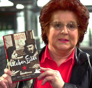 Marita Lorenz  shows her book  recently. 