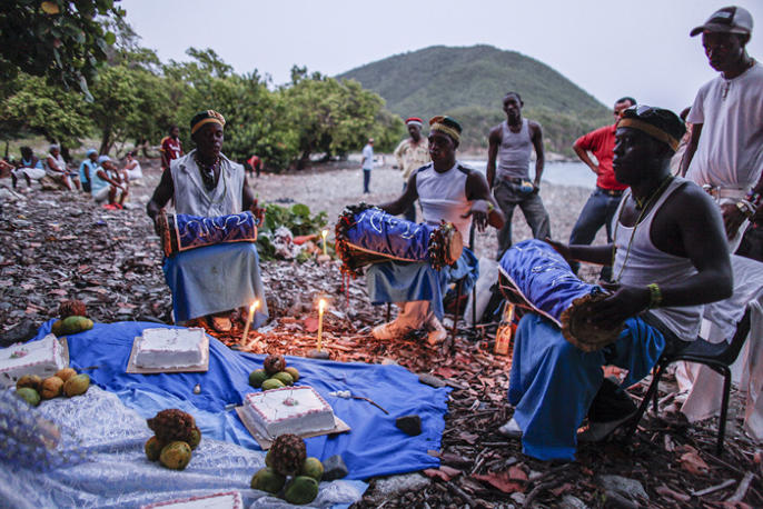 People play drums for an African-Cuban religious Santeria ceremony in honor of ocean goddess Yemaya .