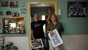 A Cuban couple, fan of British iconic band The Beatles, shows posters of the group at their house in Havana, on March 12, 2017. (Yamil Lage / AFP)