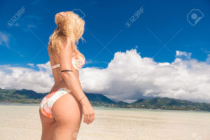 Woman on the beach looking away.