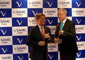 Arturo Garcia (L), president of SAHIC and David Scowsill, president and CEO of the World Travel & Tourism Council (WTTC) adjust their ties during the annual Latin American Hotel and Tourism Investment Conferences meeting in Havana, Cuba May 15, 2017.  REUTERS/Stringer