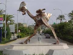 "The rooster of Morón, without feathers and cackling.  Statue in Seville, Spain.