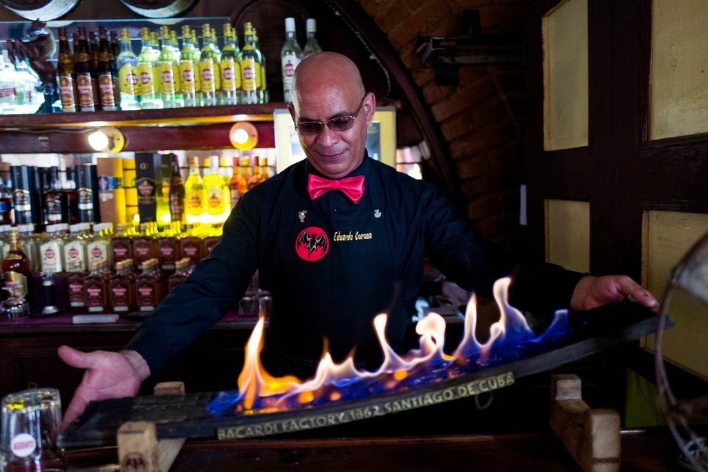 The smoke from this flaming barrel stave is used in the creation of a mojito. Eliana Aponte Tobar for The New York Times